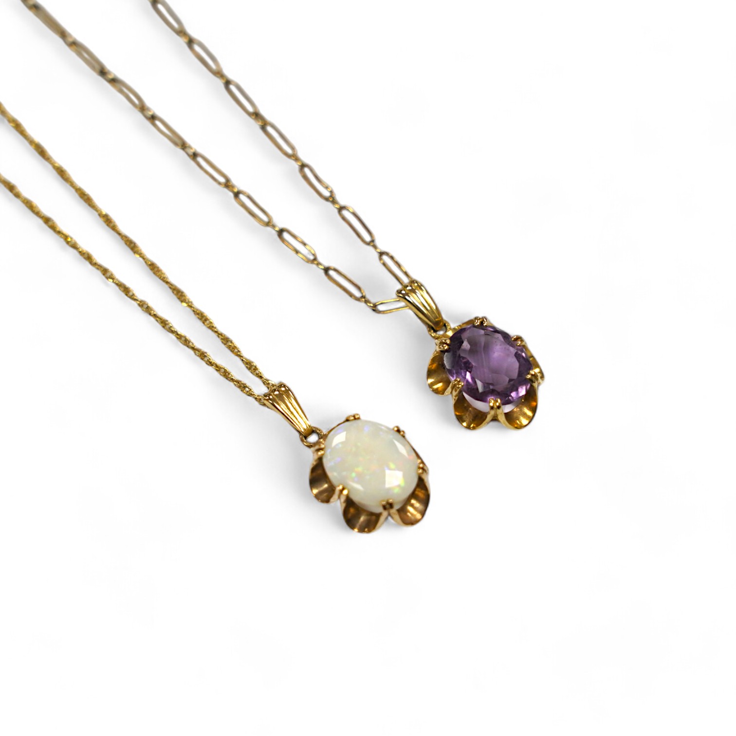 A modern 9ct gold and white opal set pendant, 21mm on a 14k chain, 46cm, gross weight 3.8 grams and a 9ct gold and amethyst set pendant on a yellow metal chain, gross weight 5 grams. Condition - fair